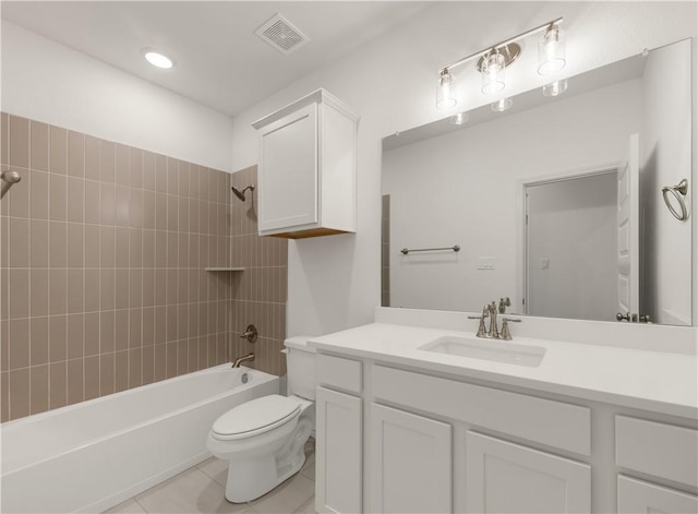 full bathroom with tiled shower / bath, tile patterned floors, toilet, and vanity