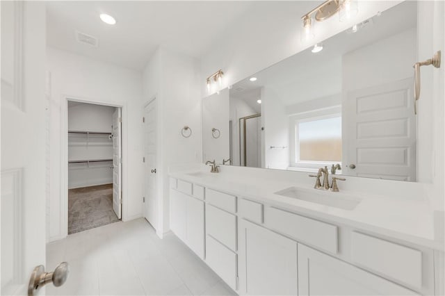 bathroom with vanity, tile patterned floors, and walk in shower