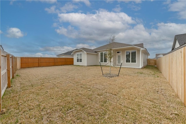 rear view of property featuring a yard