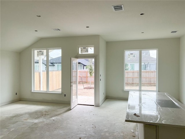 doorway to outside with vaulted ceiling