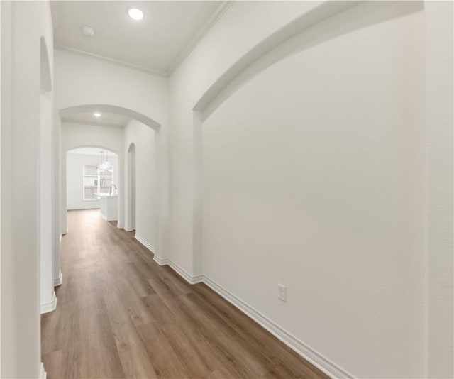 hall with crown molding and hardwood / wood-style floors