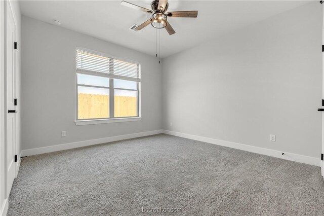 empty room with ceiling fan and carpet floors