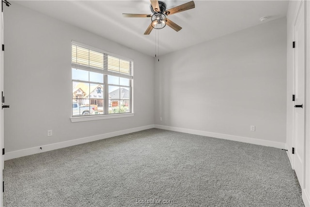 spare room with carpet floors and ceiling fan