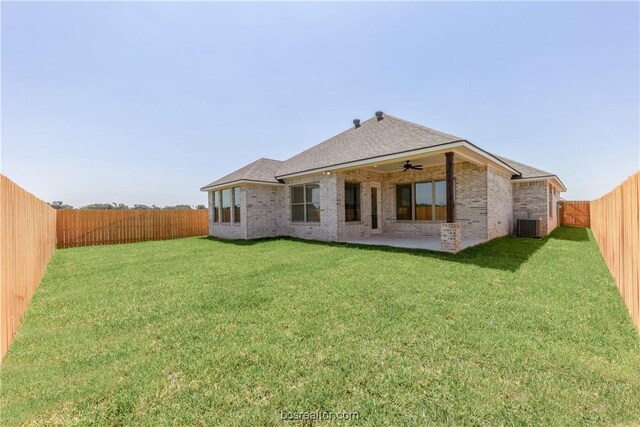 rear view of house featuring a lawn, a patio area, ceiling fan, and central AC unit