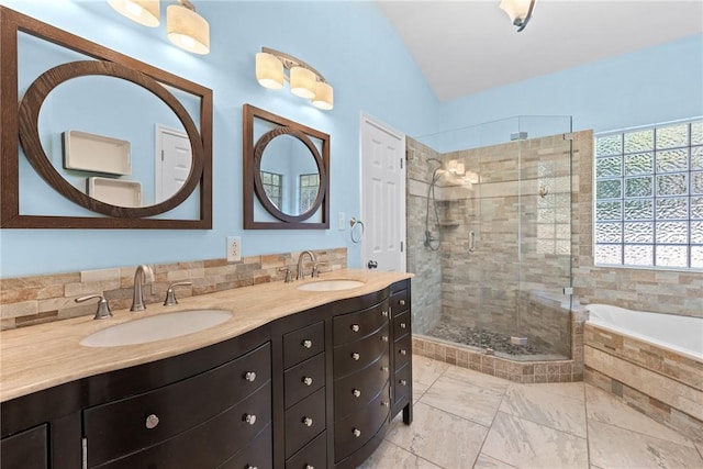 bathroom featuring vanity, shower with separate bathtub, and vaulted ceiling