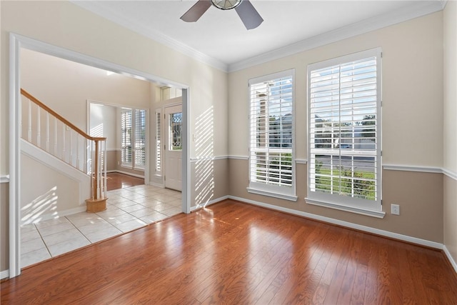 spare room with ceiling fan, light hardwood / wood-style floors, and ornamental molding