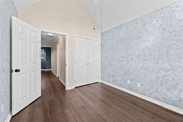 spare room featuring dark hardwood / wood-style flooring, ornamental molding, and high vaulted ceiling