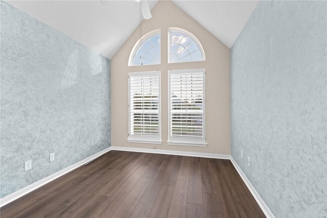 unfurnished room with dark hardwood / wood-style flooring, ceiling fan, and lofted ceiling