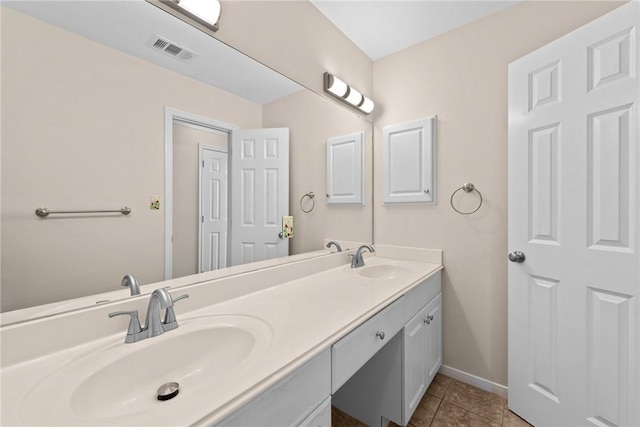 bathroom featuring tile patterned flooring and vanity