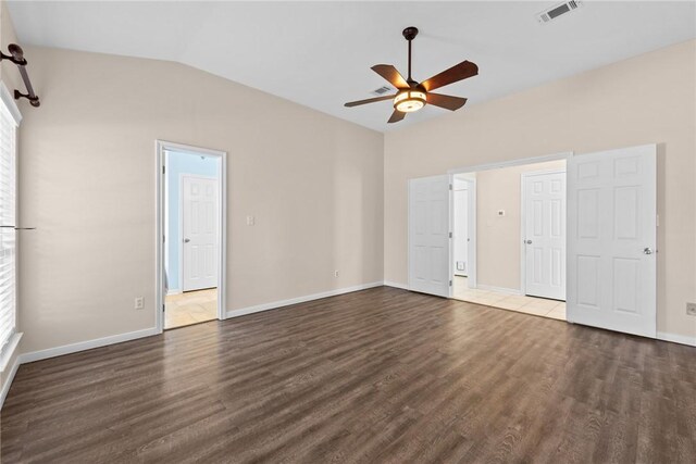 spare room featuring dark hardwood / wood-style flooring, ceiling fan, and lofted ceiling