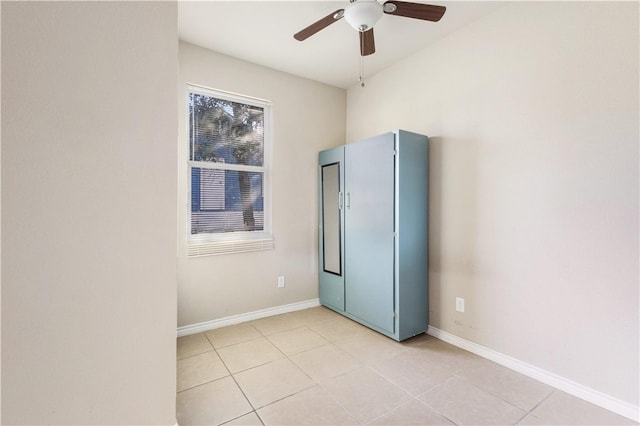 205 E 2nd St, Hearne, TX 77859 - unfurnished bedroom with light tile patterned floors, baseboards, and ceiling fan