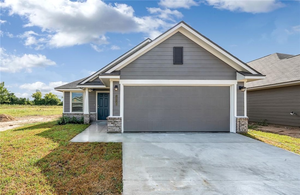 craftsman-style home with a front lawn and a garage