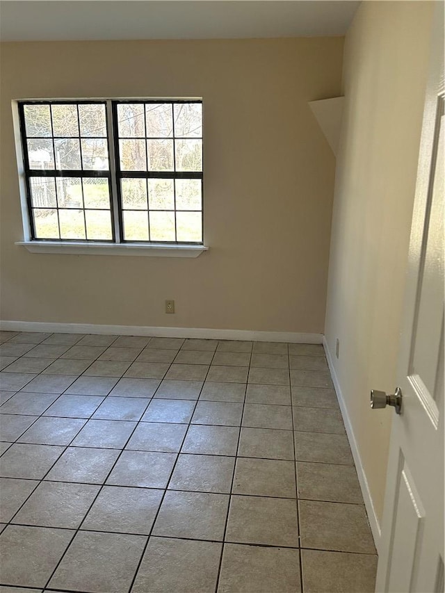 unfurnished room featuring light tile patterned flooring