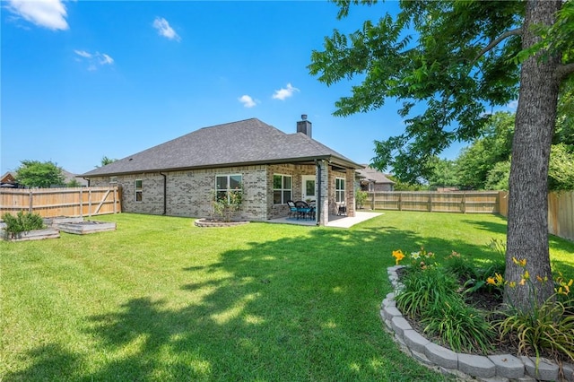 2987 Archer Dr, Bryan, TX 77808 - back of property with a patio, brick siding, and a chimney