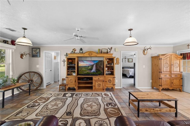 living room featuring ceiling fan and crown molding