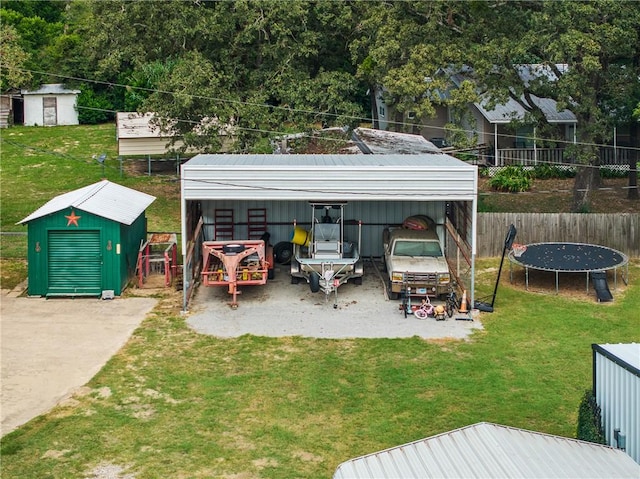 view of yard with a trampoline and a storage unit