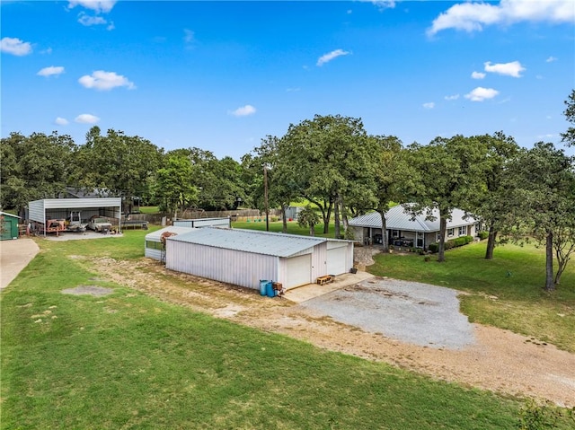 view of yard featuring a carport and an outdoor structure