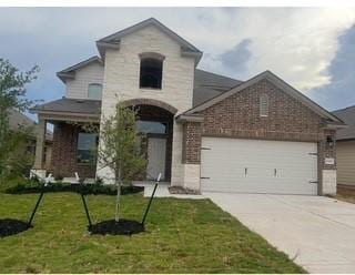 6244 Darlington Ave, College Station, TX 77845 - french country inspired facade with an attached garage, driveway, a front lawn, and brick siding
