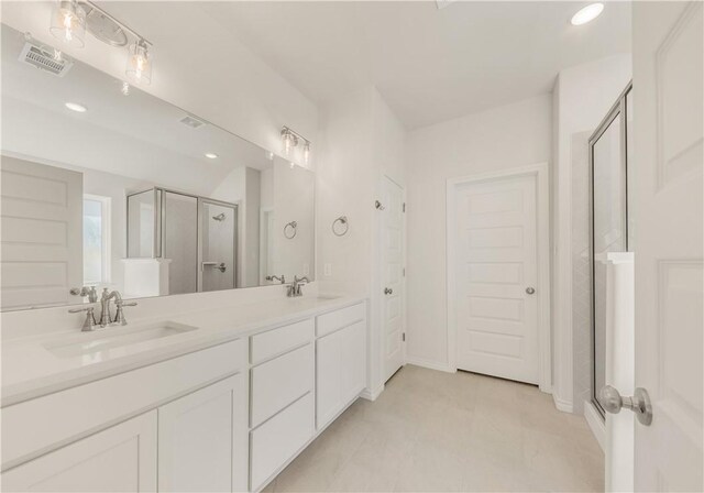 bathroom featuring tile patterned floors, vanity, and an enclosed shower