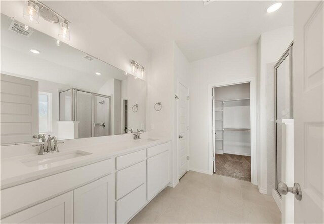 bathroom with vanity, tile patterned floors, and a shower with shower door