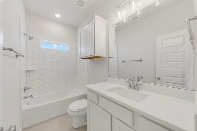 full bathroom with vanity, tiled shower / bath combo, toilet, and tile patterned flooring