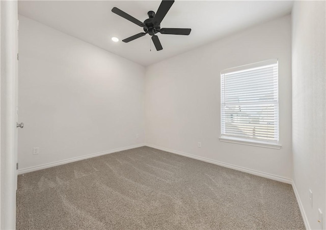 spare room with carpet floors and ceiling fan