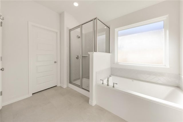 bathroom with separate shower and tub and a healthy amount of sunlight