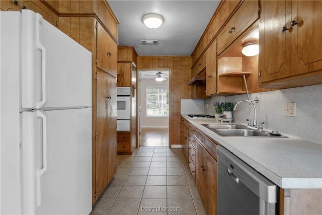 kitchen with ceiling fan, sink, stainless steel appliances, tasteful backsplash, and light tile patterned flooring