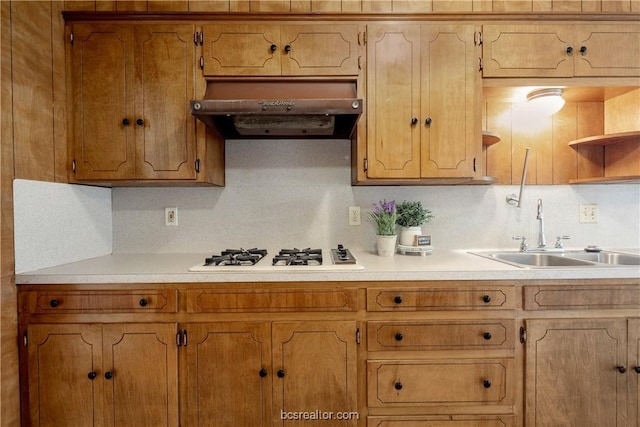 kitchen with decorative backsplash, white gas cooktop, and sink