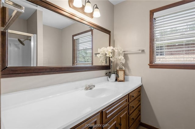 bathroom featuring vanity, walk in shower, and a wealth of natural light