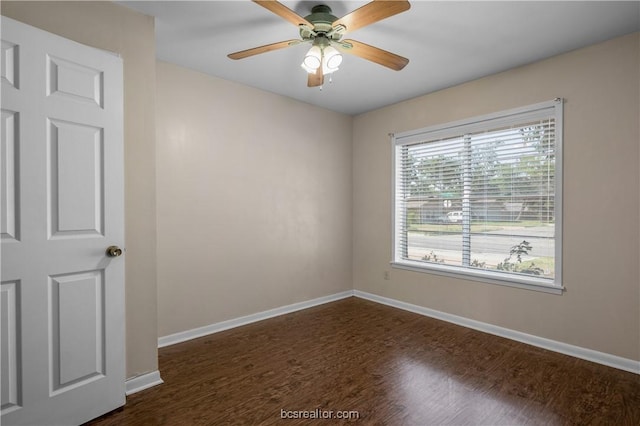 empty room with dark hardwood / wood-style floors and ceiling fan