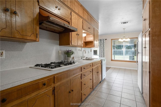 kitchen featuring sink, white gas cooktop, stainless steel dishwasher, ventilation hood, and decorative light fixtures