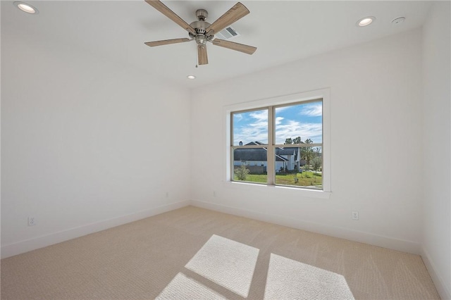 carpeted empty room featuring ceiling fan