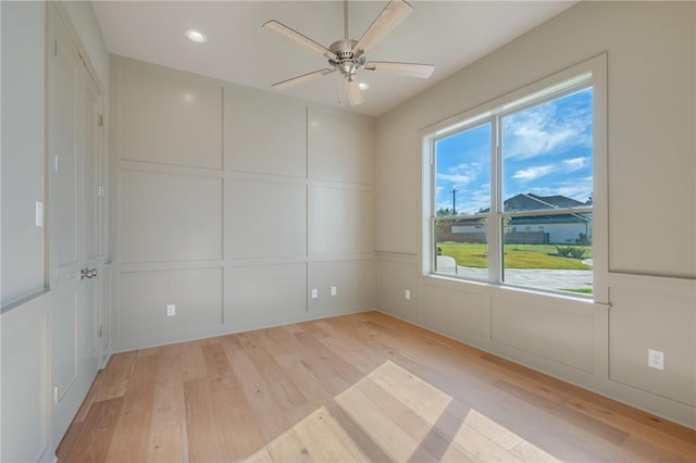 unfurnished room with ceiling fan and light wood-type flooring