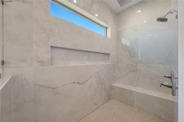 bathroom with tiled shower