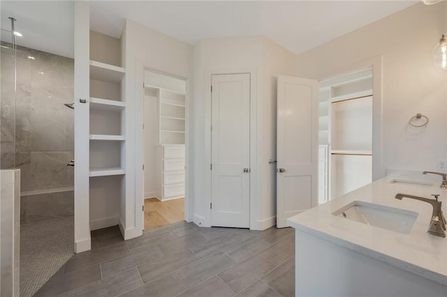 bathroom featuring vanity and tiled shower