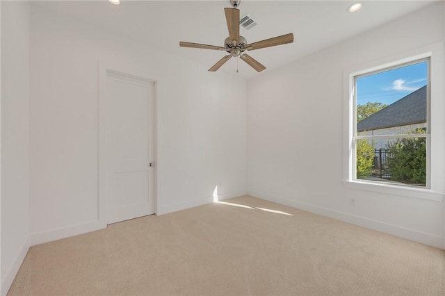 carpeted spare room with ceiling fan