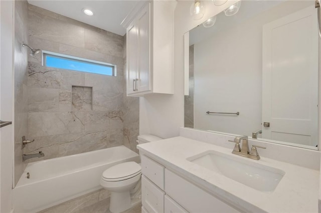 full bathroom with tiled shower / bath, vanity, and toilet