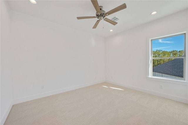 empty room with ceiling fan and light colored carpet