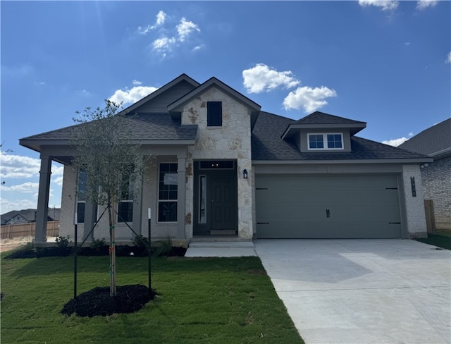 view of front facade featuring a garage and a front lawn