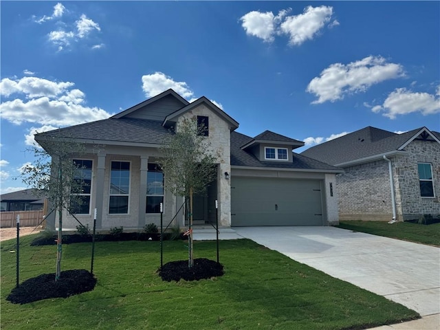 view of front of property featuring a garage and a front lawn