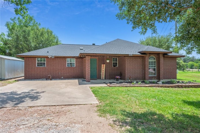 7314 Dilly Shaw Tap Rd, Bryan, TX 77808 - single story home featuring brick siding, a front yard, an outdoor structure, and a shingled roof