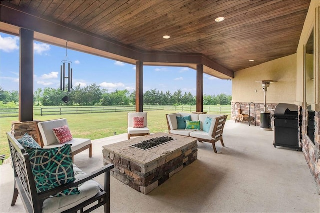 view of patio / terrace featuring an outdoor living space with a fire pit, area for grilling, and a fenced backyard
