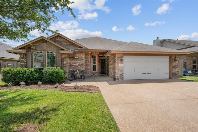 912 Emerald Dove Ave, College Station, TX 77845 - ranch-style home with brick siding, an attached garage, concrete driveway, a front yard, and a shingled roof