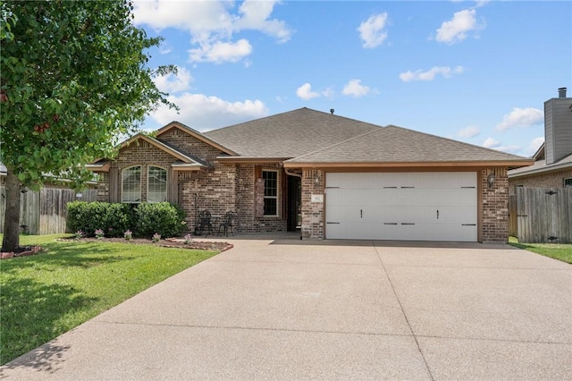 912 Emerald Dove Ave, College Station, TX 77845 - view of front of house with brick siding, concrete driveway, an attached garage, and a shingled roof