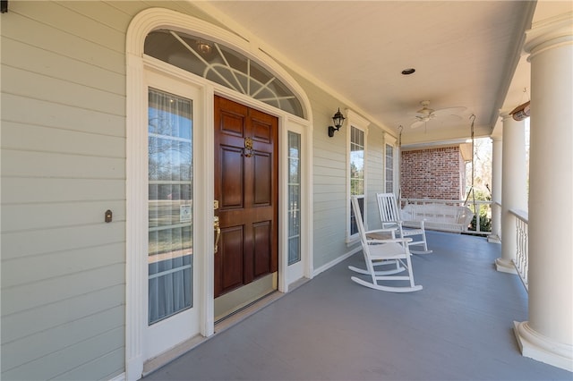 doorway to property with covered porch and a ceiling fan