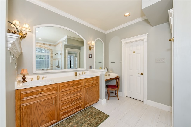 full bath featuring crown molding, double vanity, a sink, tiled shower, and baseboards