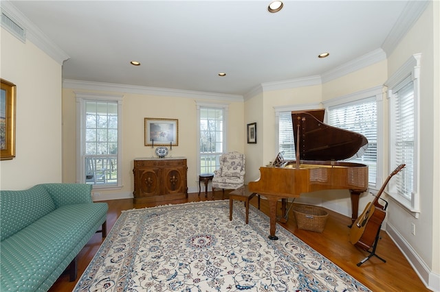 sitting room featuring a wealth of natural light, visible vents, and wood finished floors