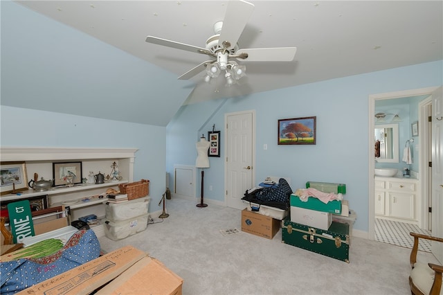 interior space featuring carpet floors, lofted ceiling, ceiling fan, and baseboards