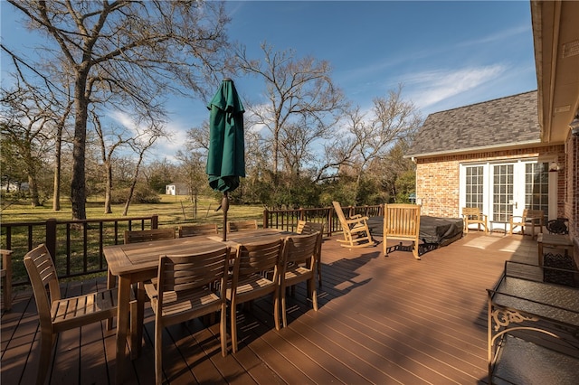 deck with french doors and outdoor dining space